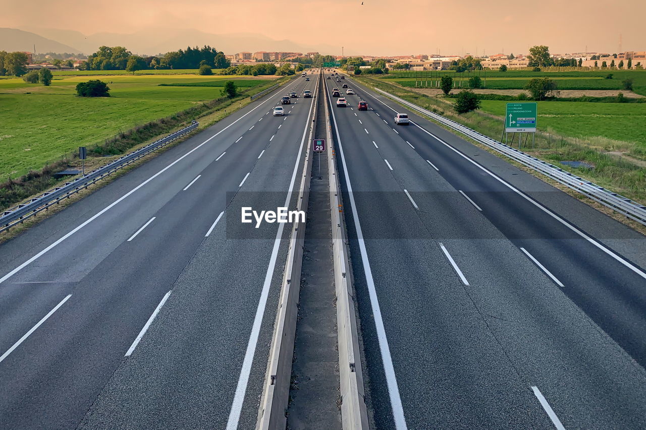 Motorway with flowing traffic seen from above.