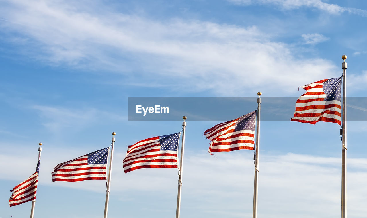 A group of american flags waving on a sunny day. concept of patriotism and democracy