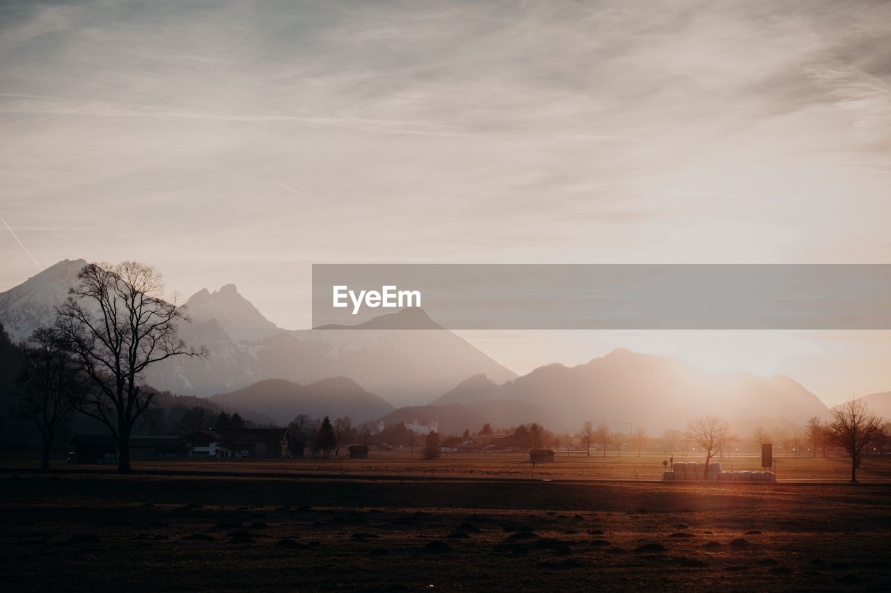 Scenic view of field against sky during sunset