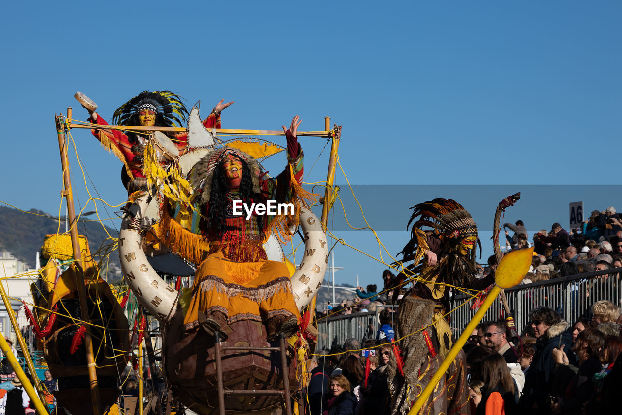 sky, tradition, arts culture and entertainment, carnival, festival, group of people, crowd, event, nature, clear sky, celebration, large group of people, outdoors, performance, day, men, adult, traditional festival, person, music