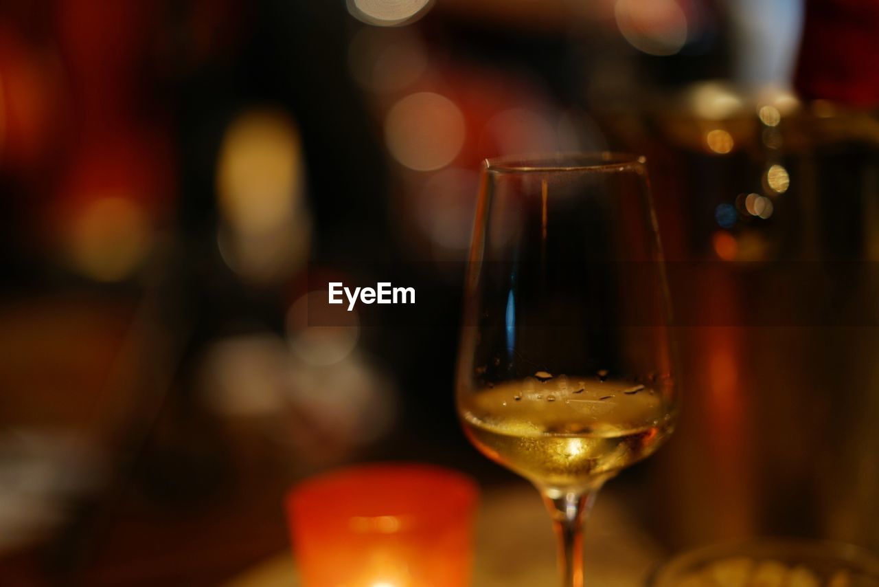 CLOSE-UP OF WINE IN GLASS ON TABLE