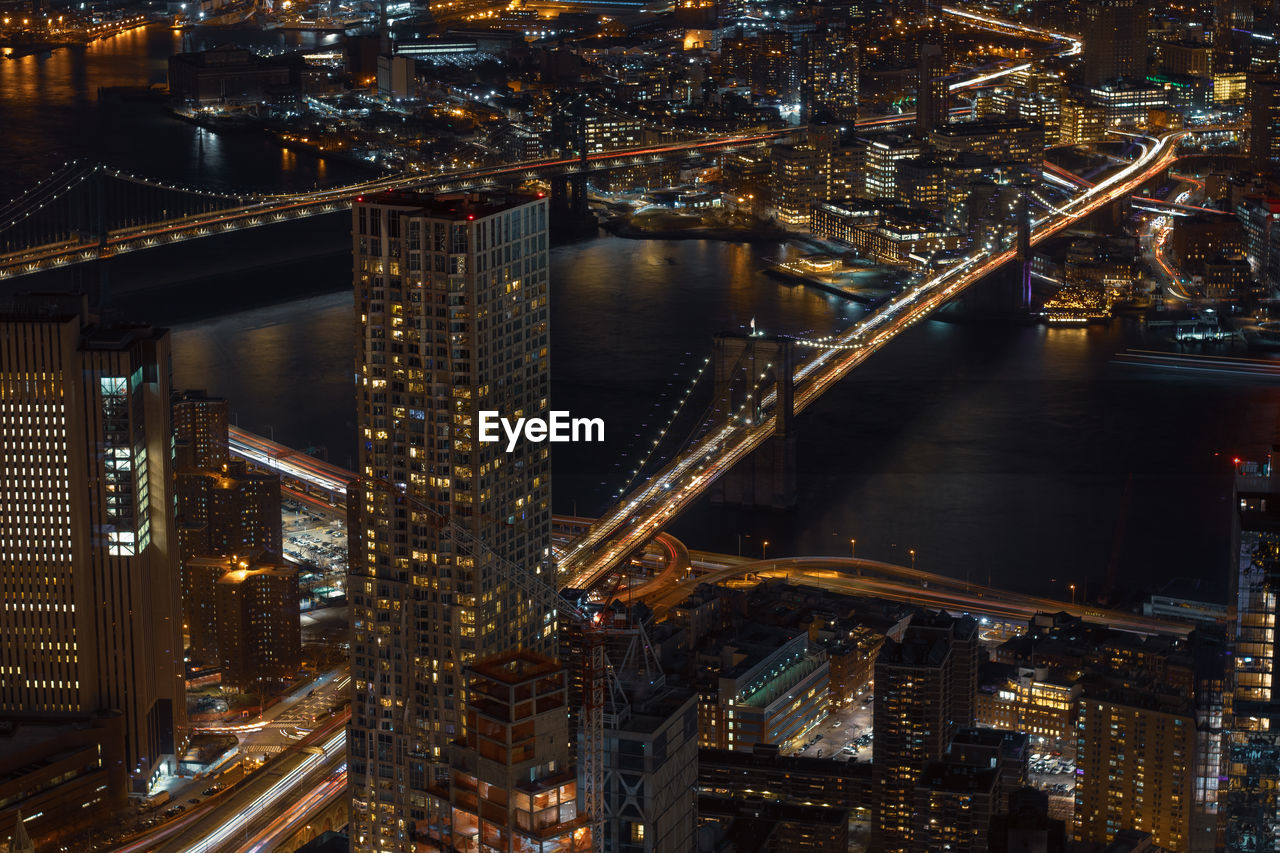 High angle view of illuminated brooklyn bridge over river in city at night