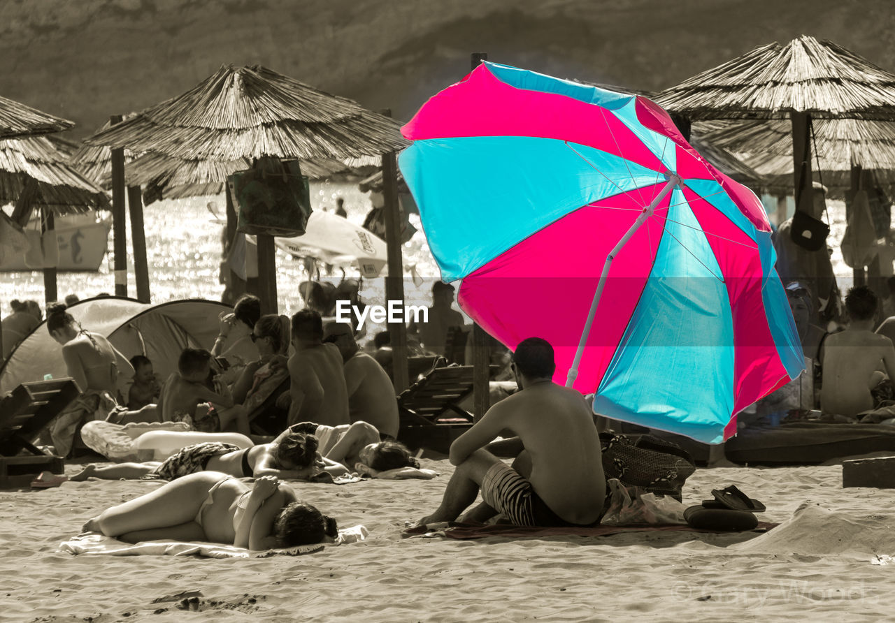 GROUP OF PEOPLE WITH UMBRELLA ON BACKGROUND