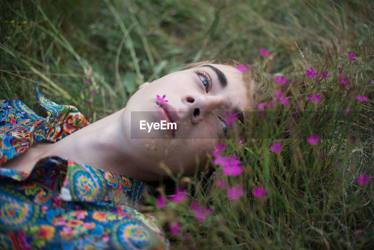 Close-up of man lying on grass