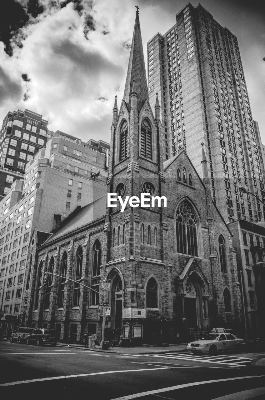 Black and white picture of a church and a skyscraper in new york