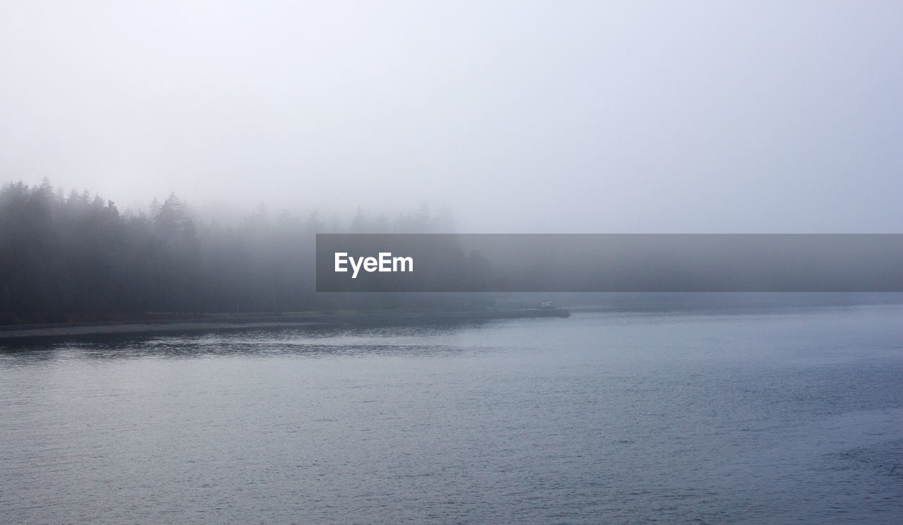 SCENIC VIEW OF LAKE AGAINST SKY IN FOGGY WEATHER