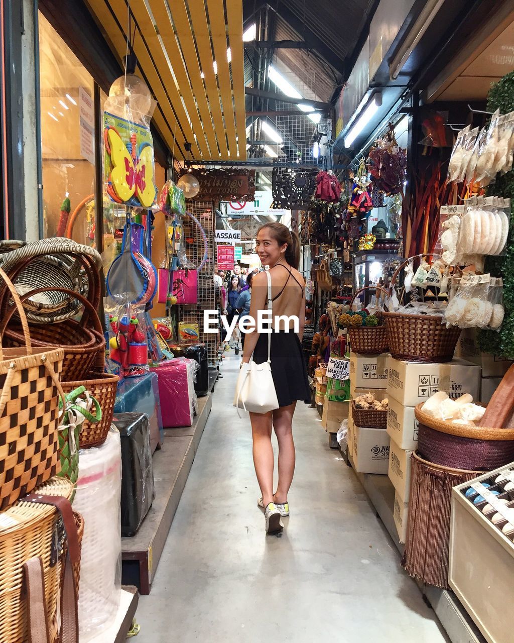 Portrait of young woman walking in market