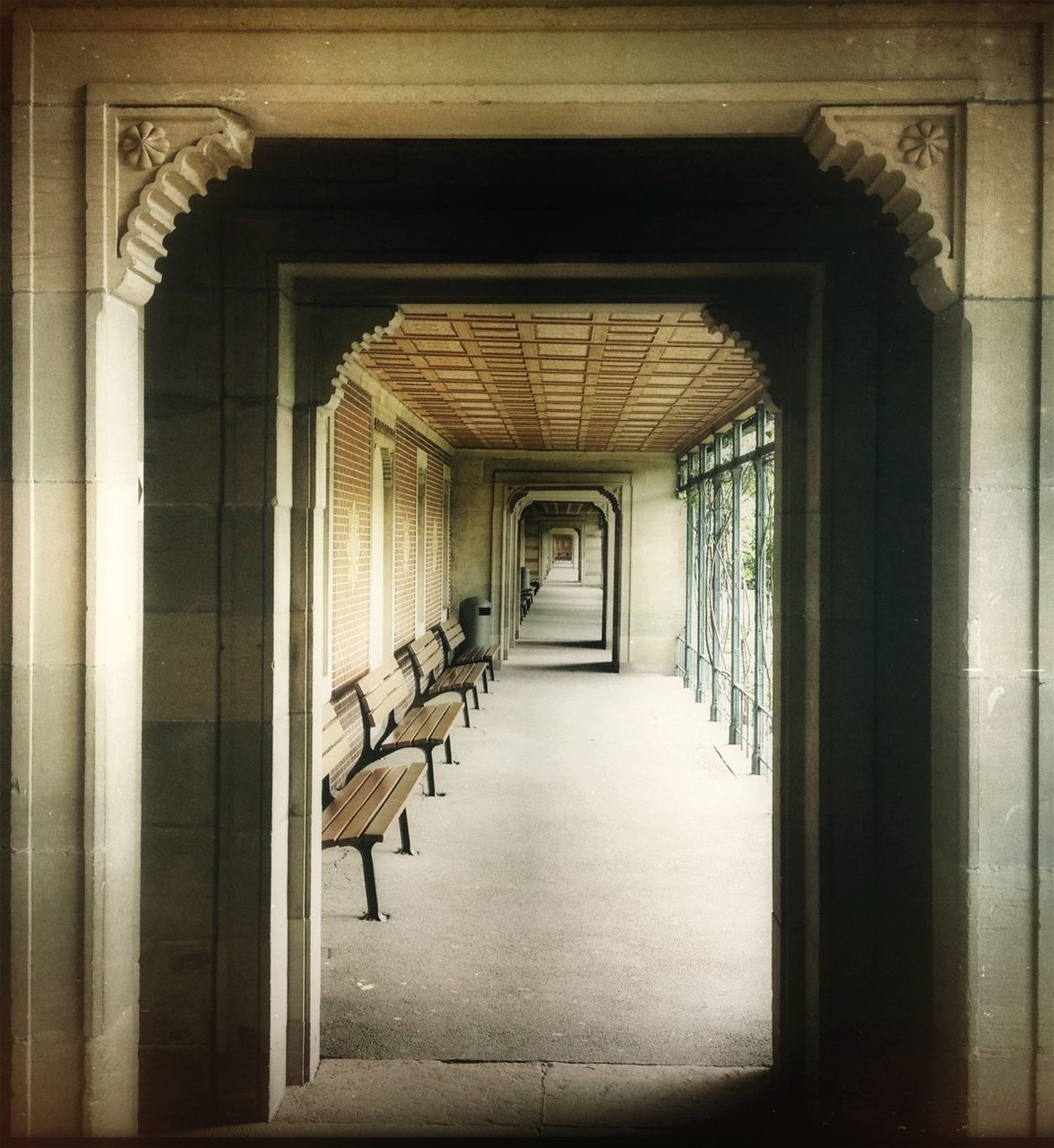 Empty benches in empty narrow corridor