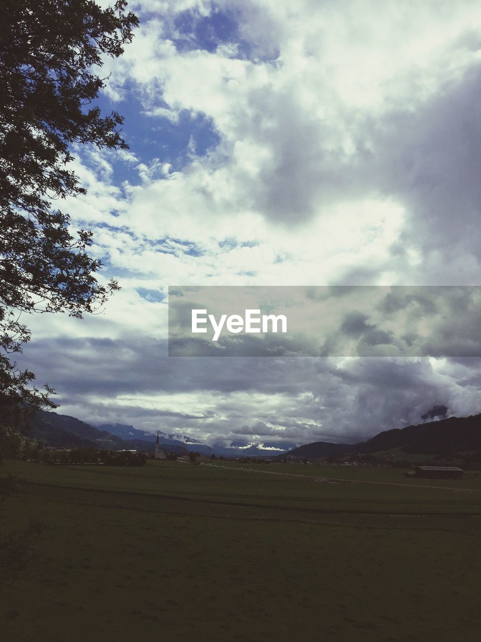 SCENIC VIEW OF FIELD AND MOUNTAIN AGAINST SKY