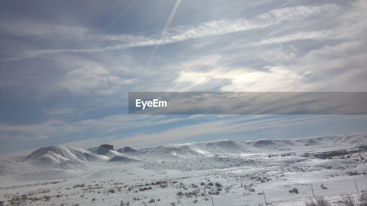 AERIAL VIEW OF LANDSCAPE AGAINST SKY DURING WINTER