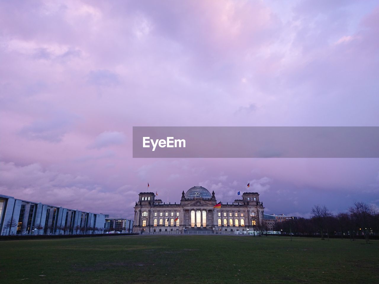 Reichstag building, seat of german parliament deutscher bundestag, during a cloudy day at sunset