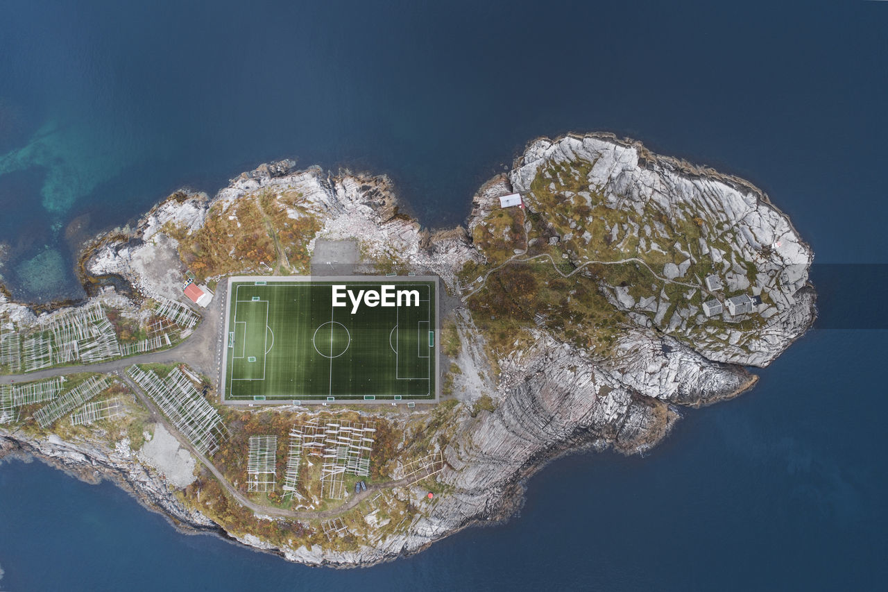 Soccer field on the cliffs of henningsvær by the sea