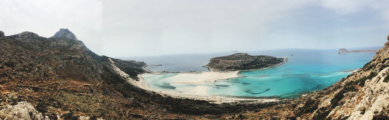 Panoramic view of sea and rocks against sky