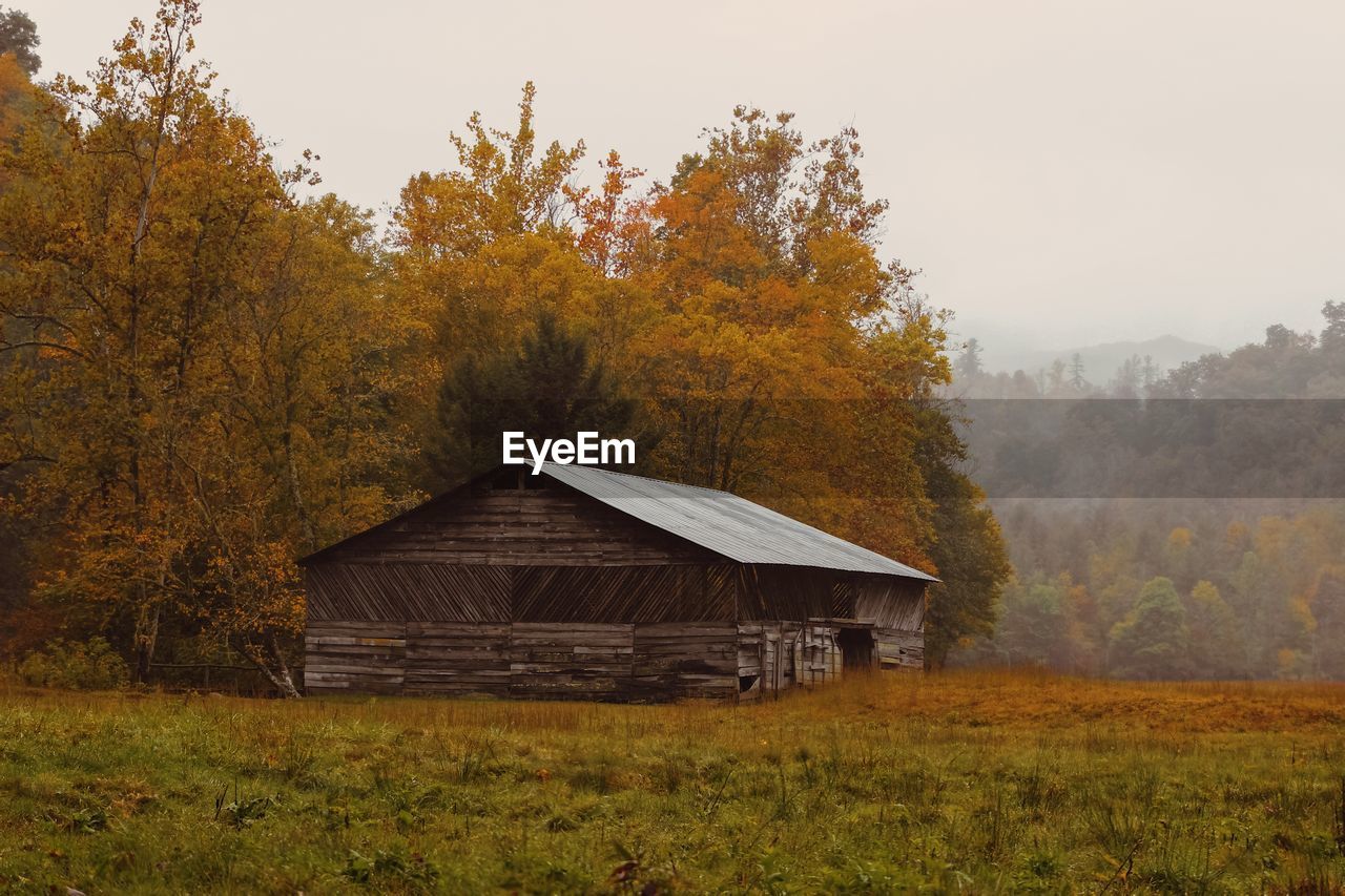 Built structure on field against sky during autumn