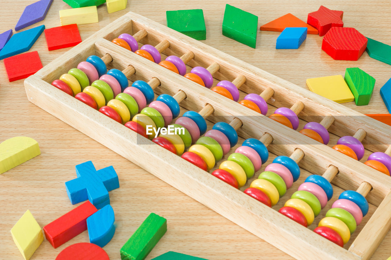 High angle view of multi colored abacus and toys on table