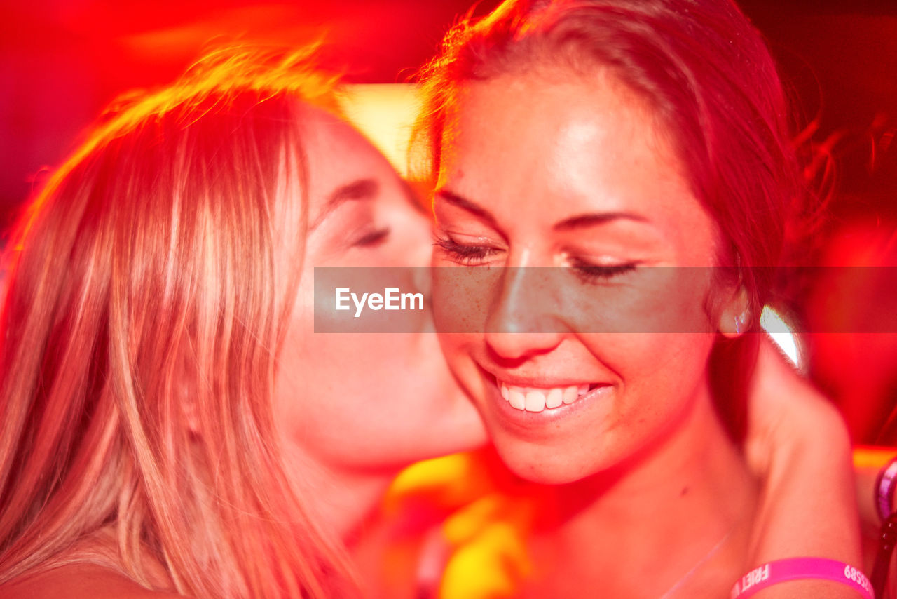 Close-up of happy female friends at nightclub