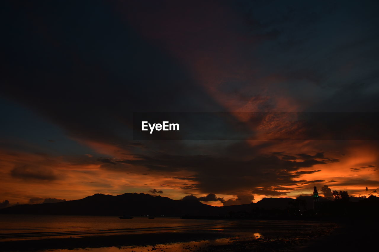 Scenic view of dramatic sky over the sea during sunset