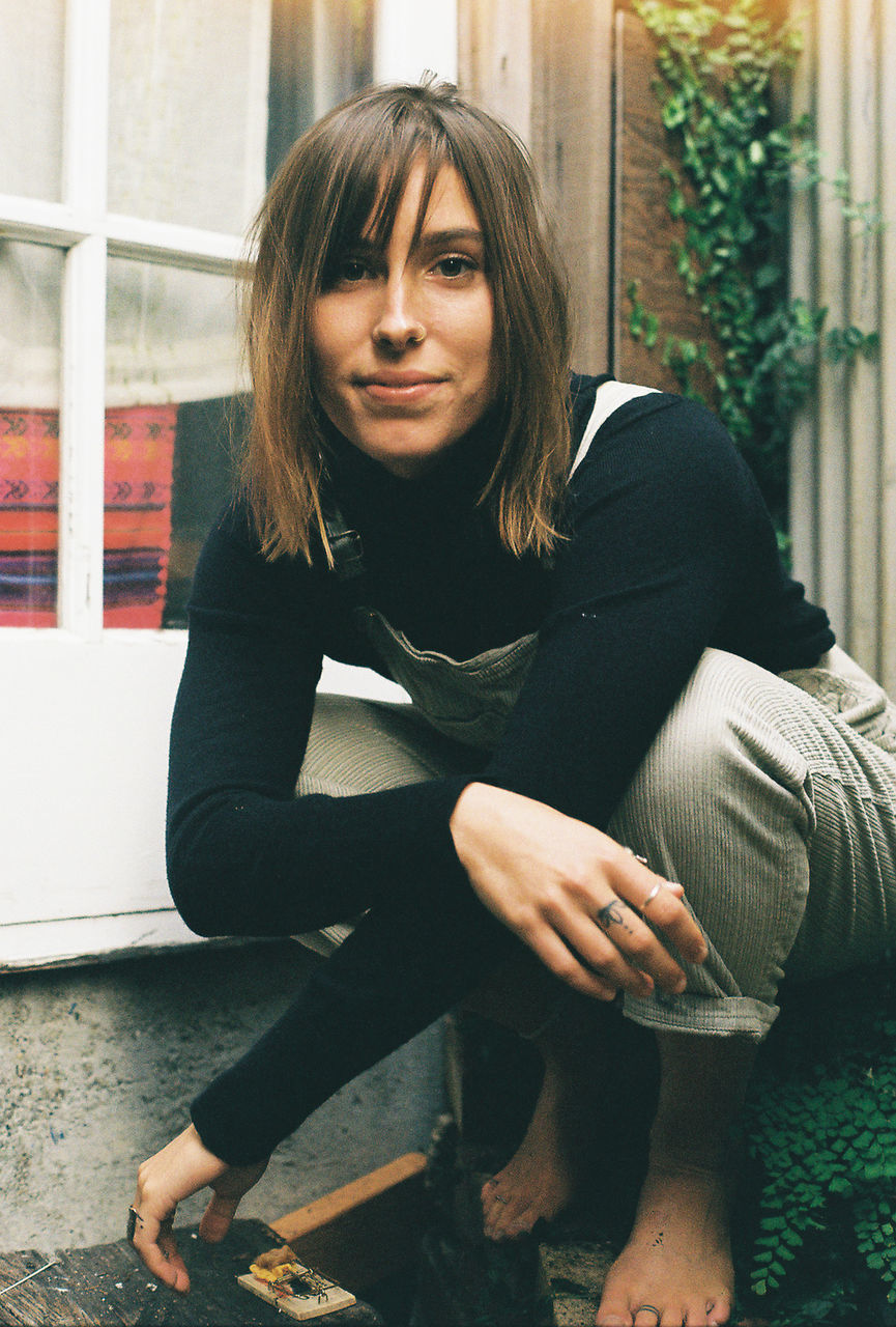 PORTRAIT OF WOMAN SITTING AT HOME