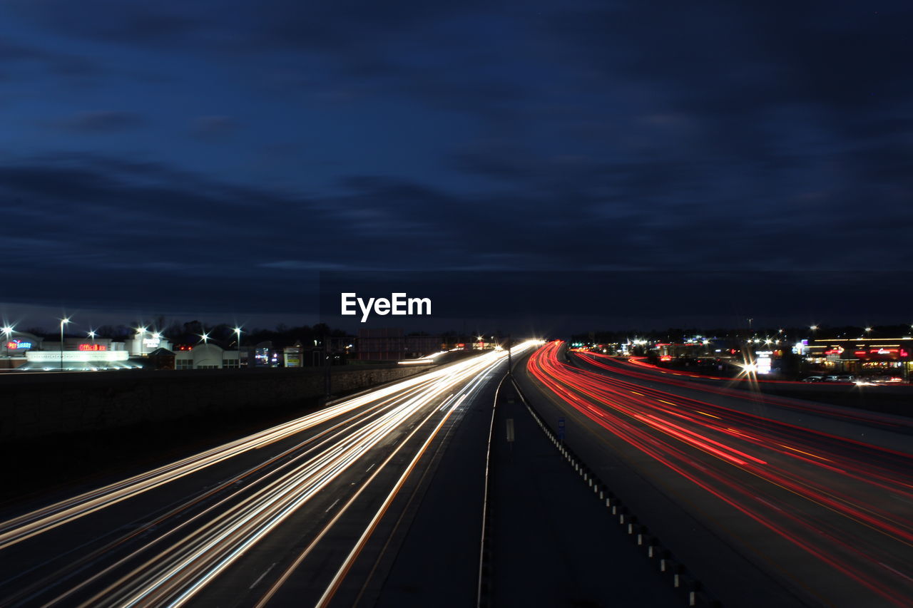 Light trails on road in city at night