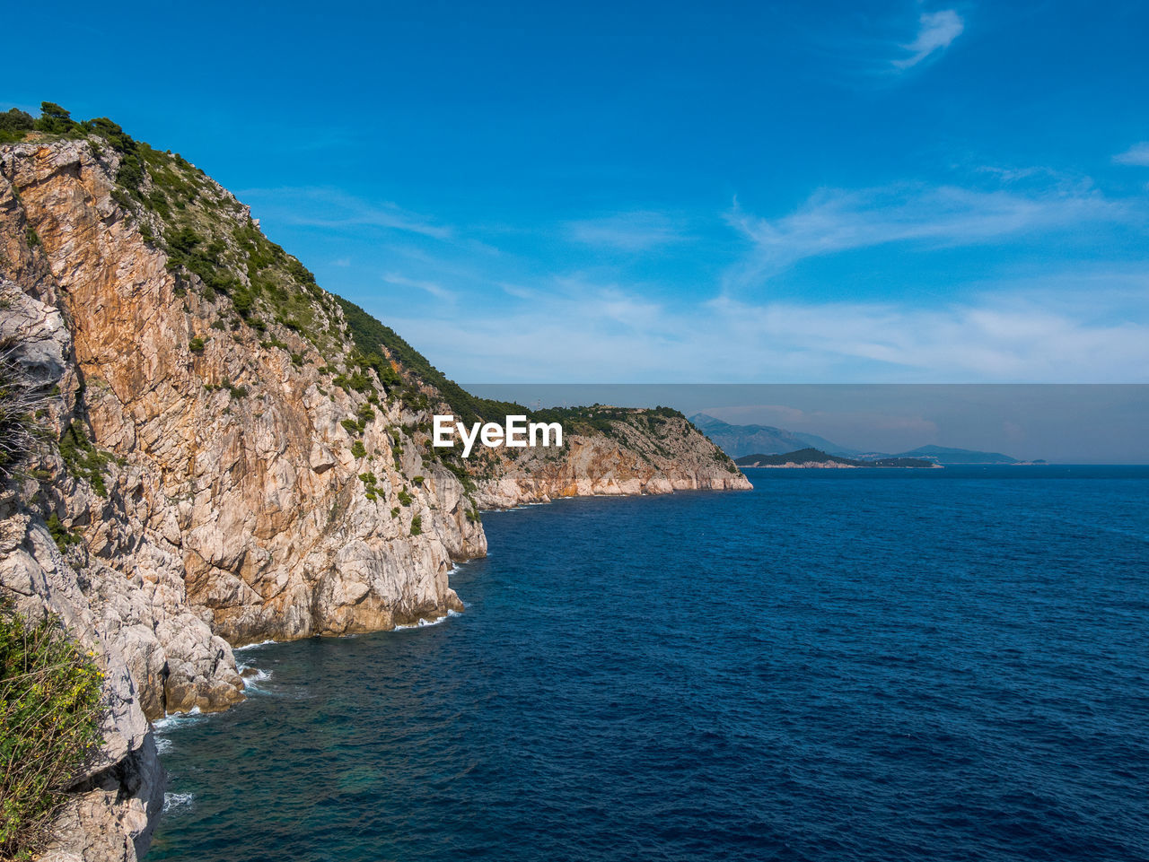 Scenic view of sea against blue sky