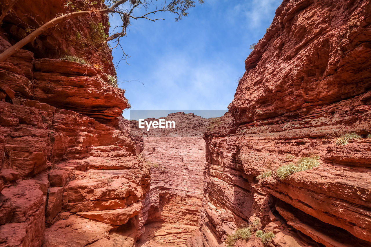 LOW ANGLE VIEW OF ROCK FORMATION ON LAND