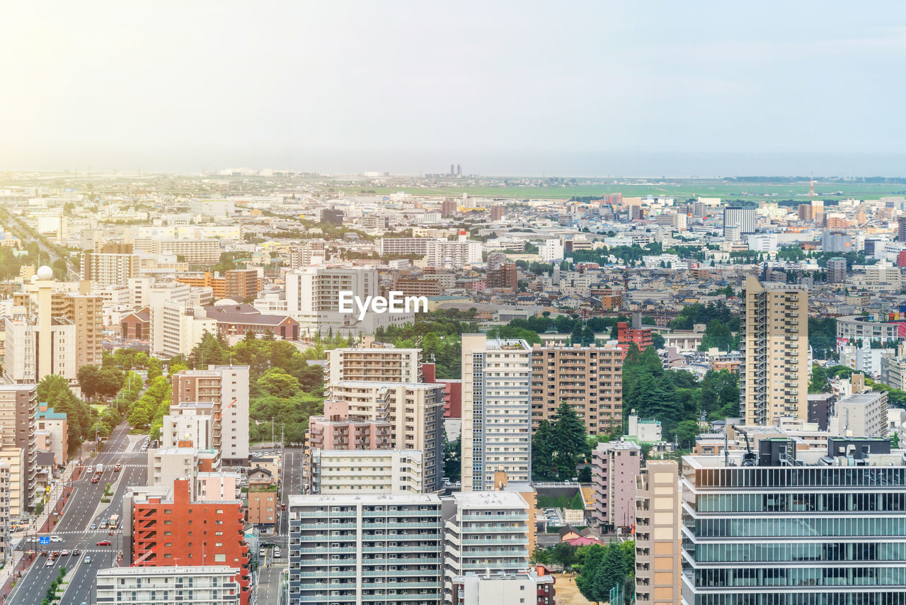 HIGH ANGLE VIEW OF CITY BUILDINGS AGAINST SKY