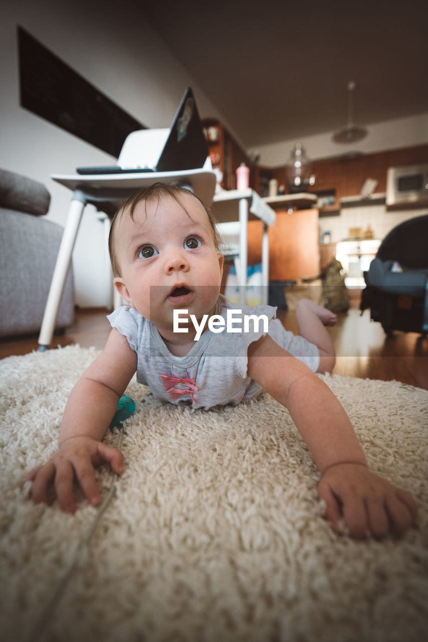 PORTRAIT OF CUTE HAPPY BABY AT HOME