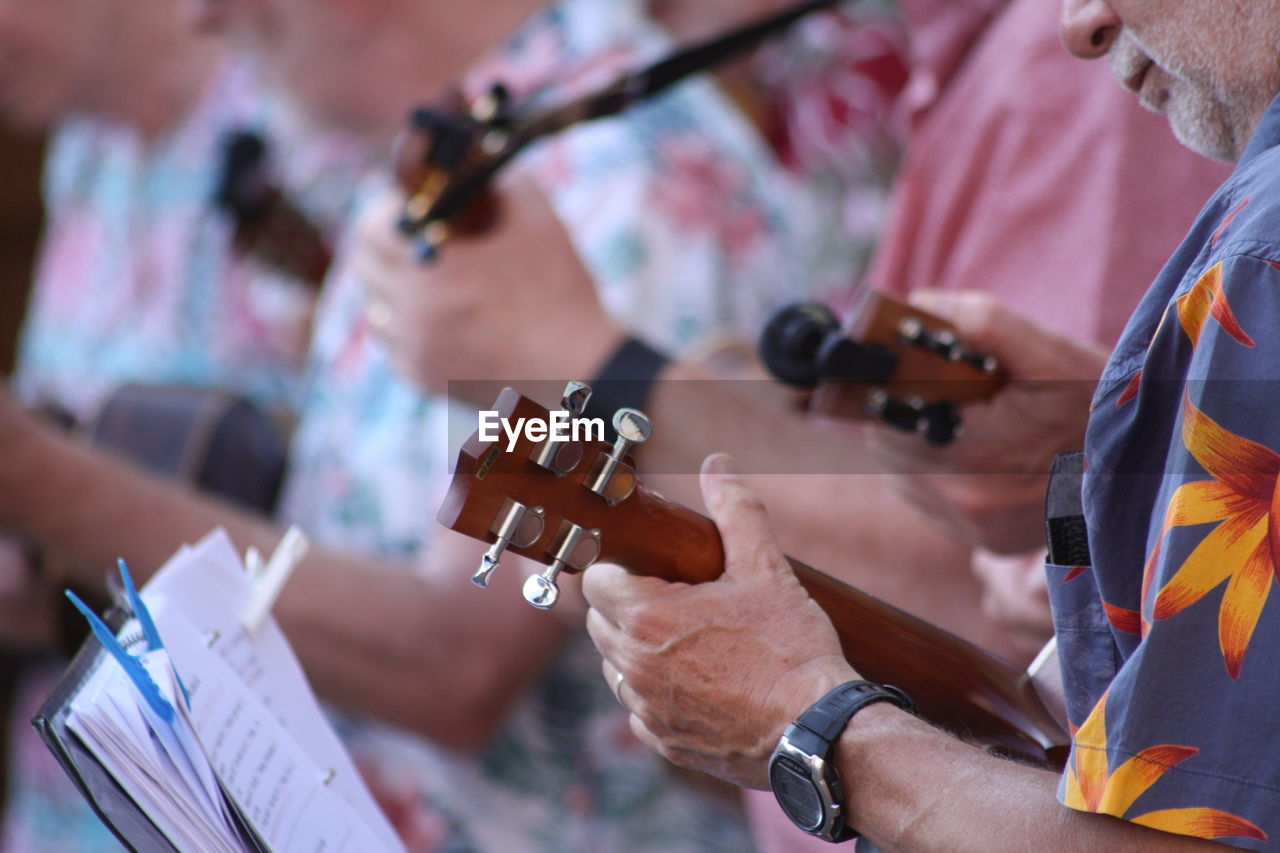 Midsection of people playing musical instruments