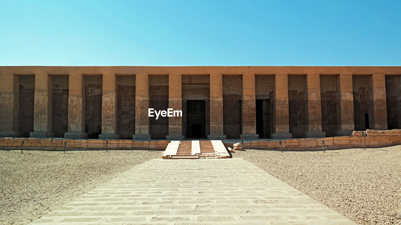 LOW ANGLE VIEW OF BUILT STRUCTURE AGAINST BLUE SKY