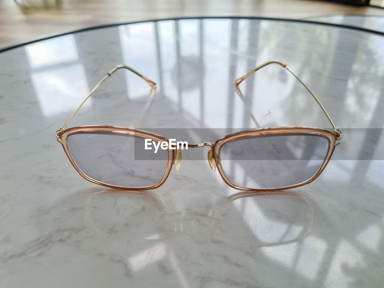 CLOSE-UP OF EYEGLASSES ON TABLE