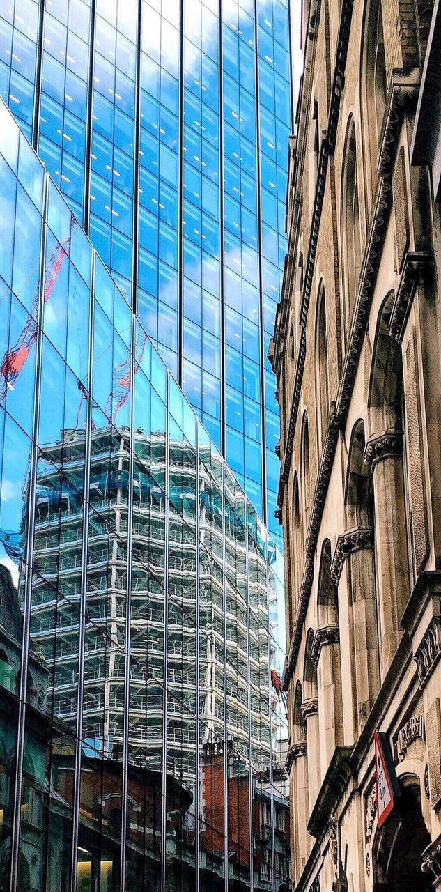 Reflection of incomplete building on skyscraper