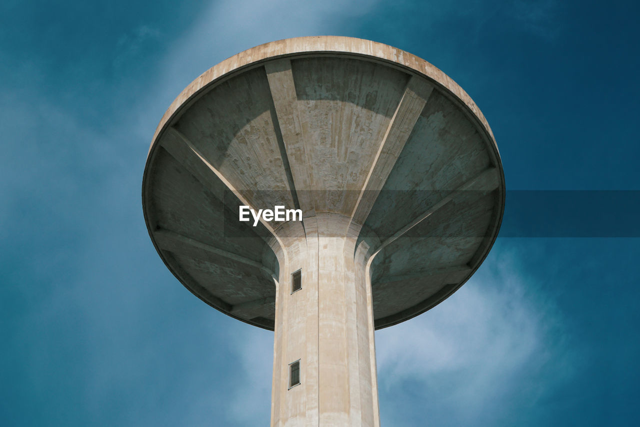 Tower of the aqueduct against blue sky, brutalist architecture