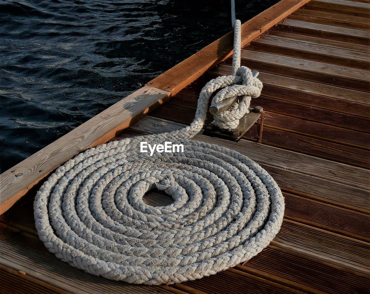 Close-up of rope tied on pier