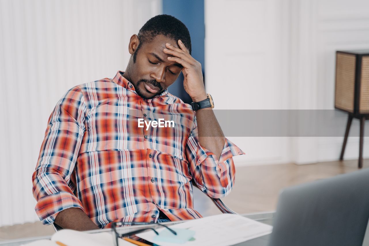 young man working at table in office