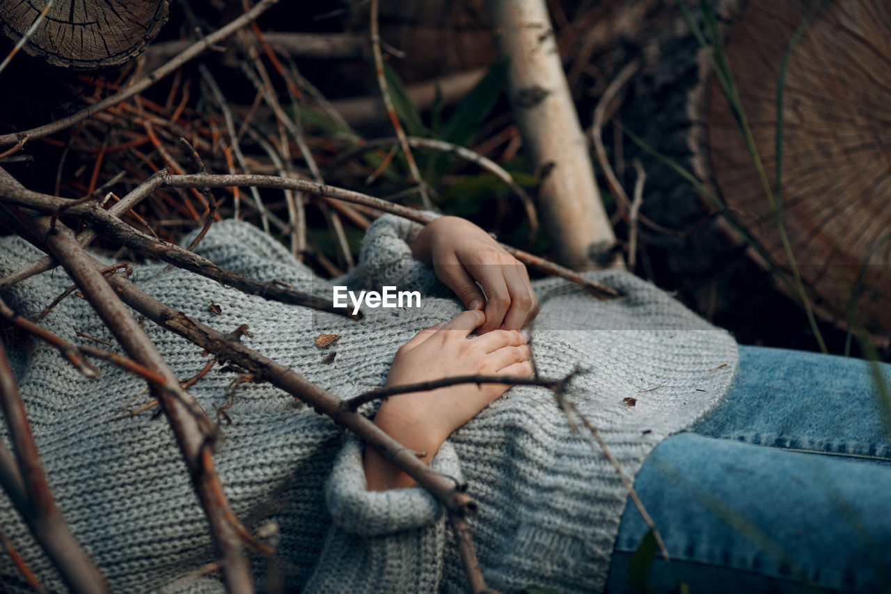 Midsection of woman lying amidst plants