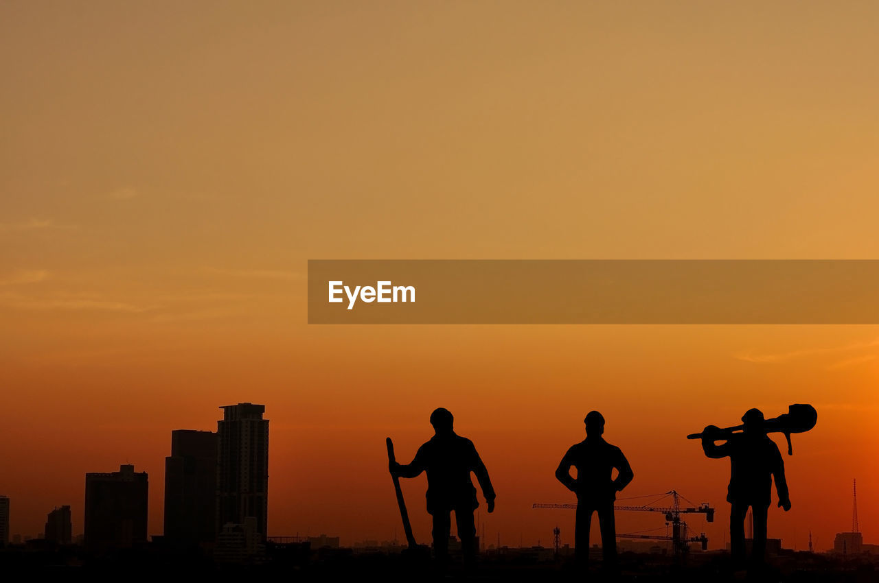 SILHOUETTE PEOPLE AGAINST ORANGE SKY DURING SUNSET