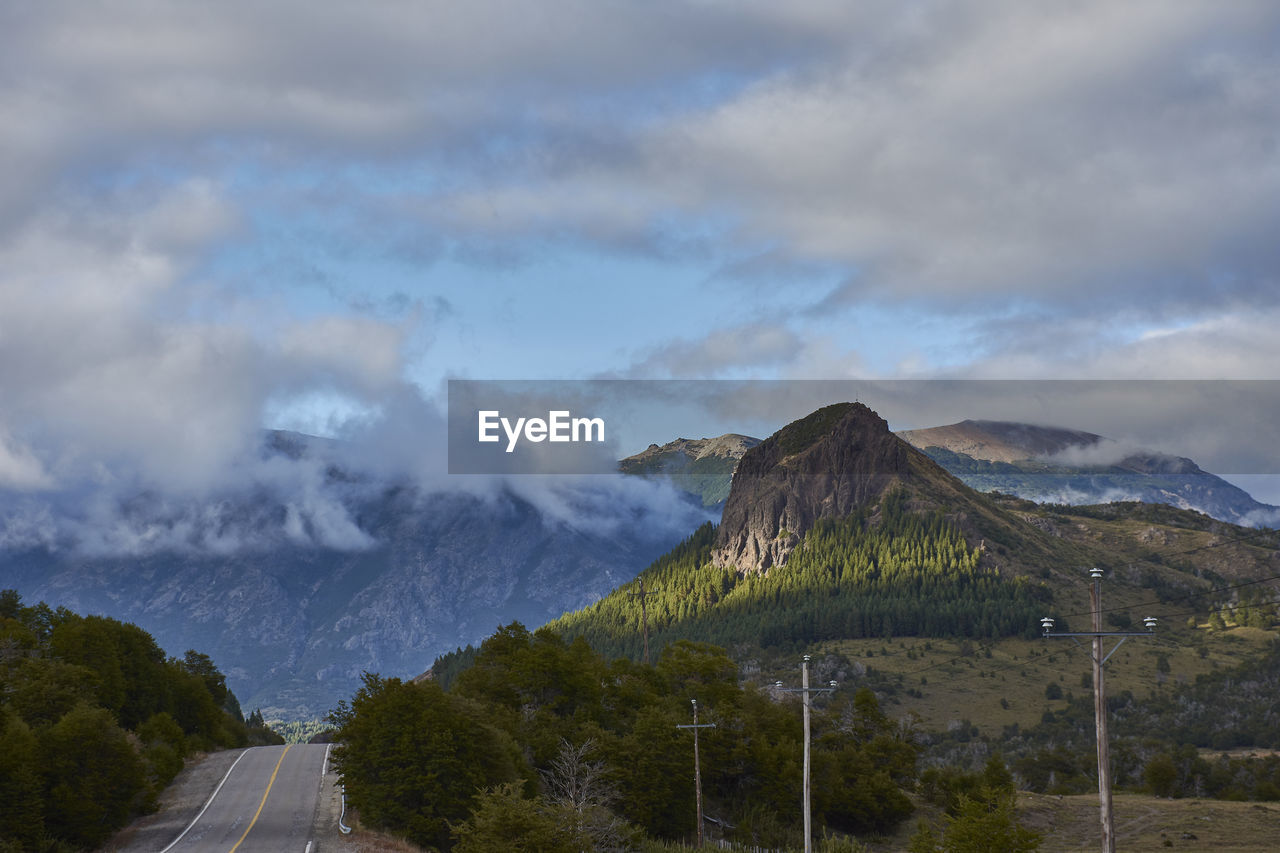 Road amidst mountains against sky