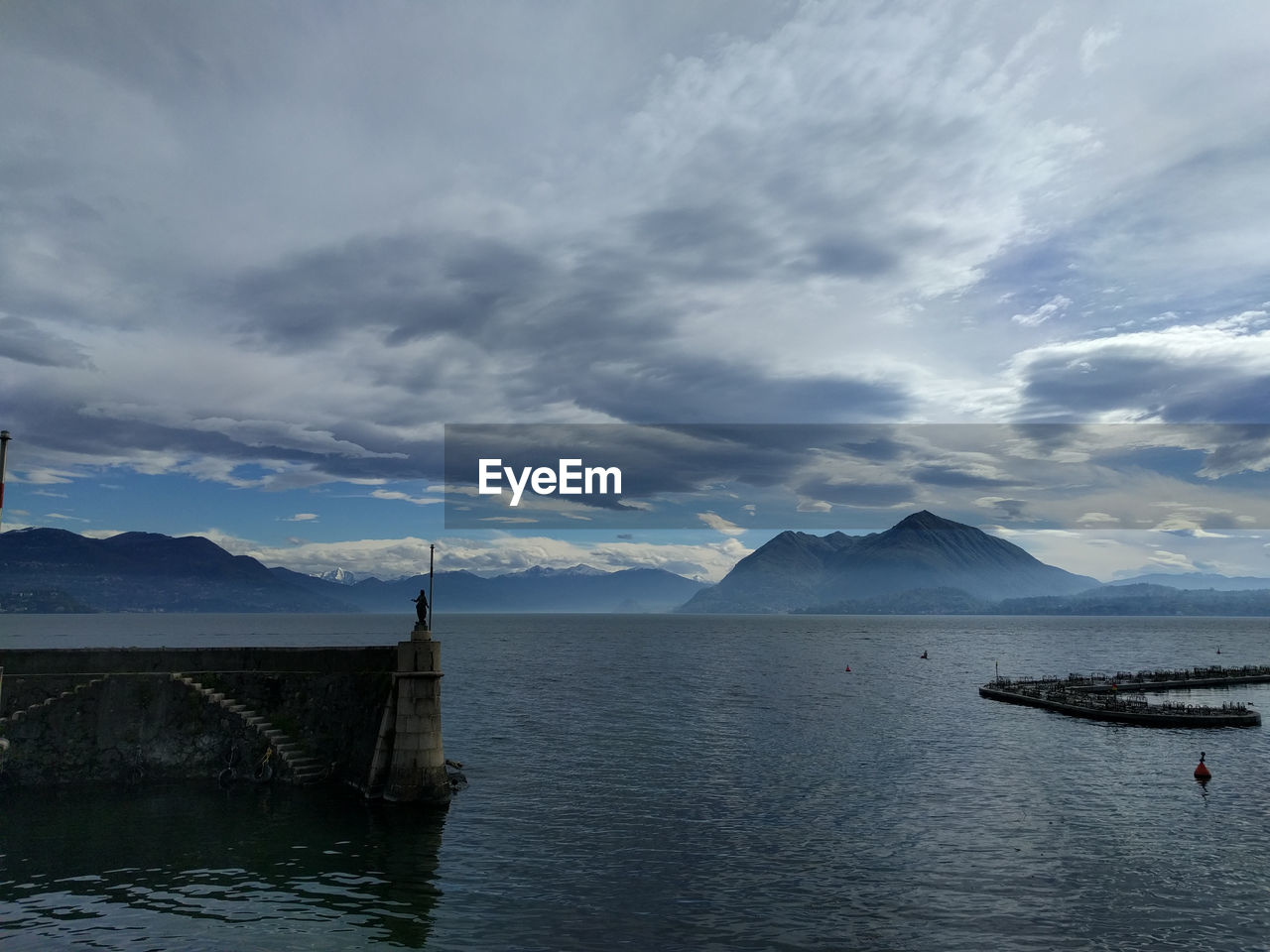 Scenic view of mountains against cloudy sky