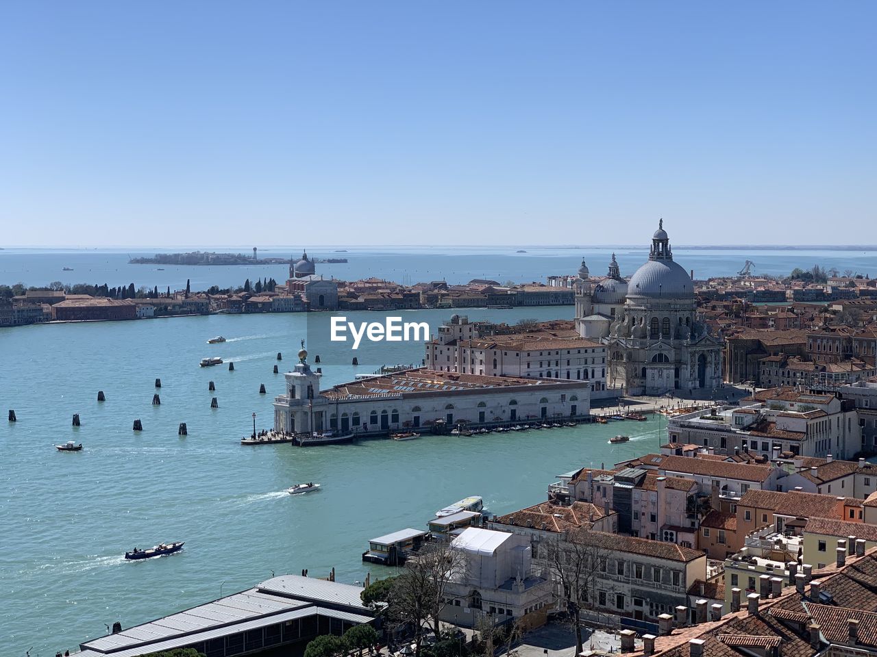 High angle view of city by grand canal against clear blue sky