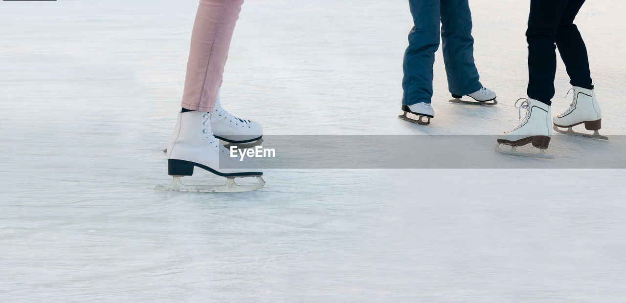 Low section of people skating on ice