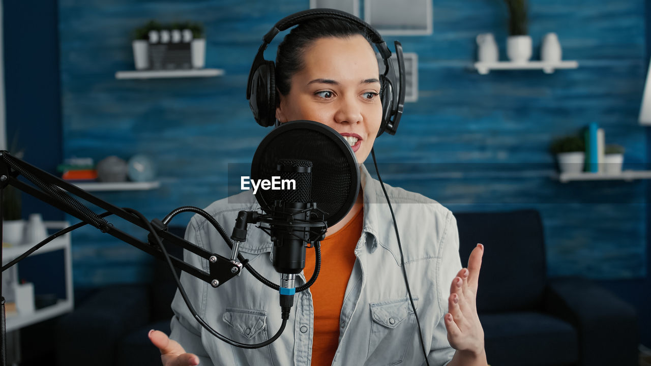 portrait of young woman with microphone at airport