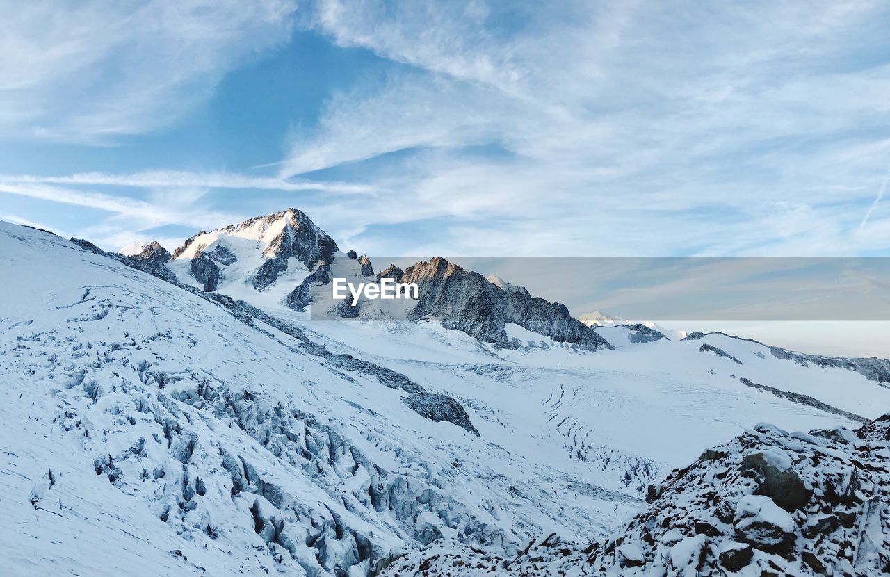 Scenic view of snowcapped mountains against sky