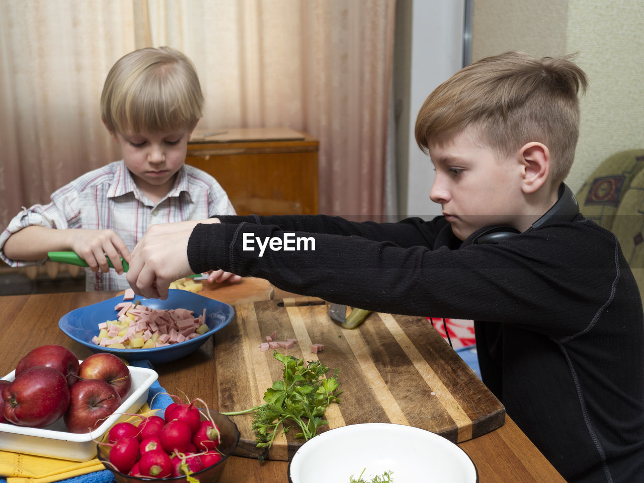 CUTE BOY AND FOOD ON TABLE AT HOME