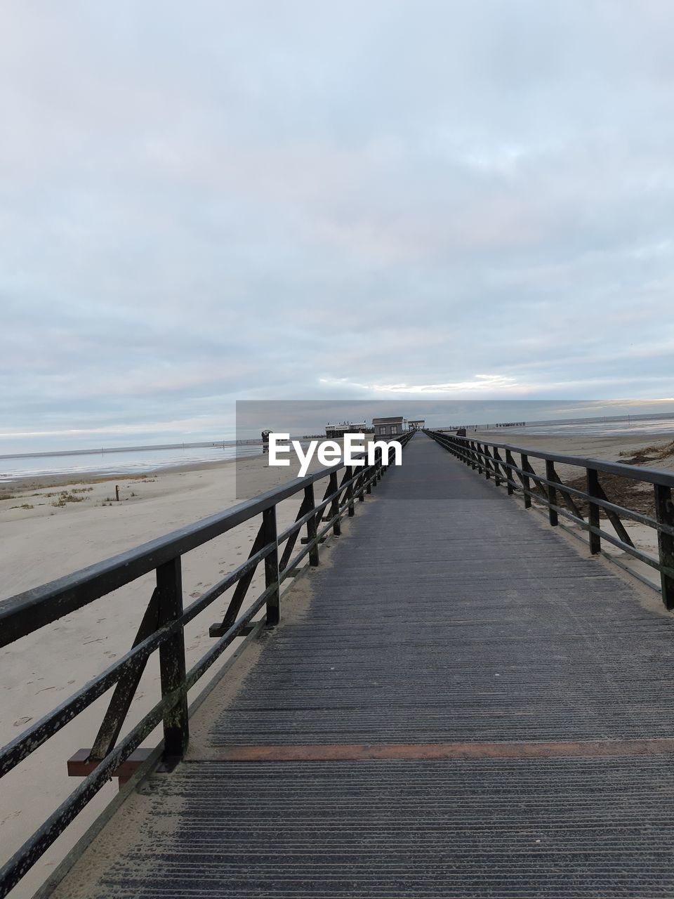 Pier over sea against sky