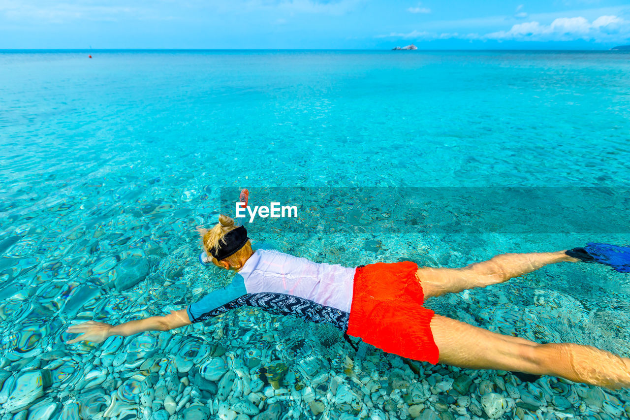 High angle view of woman snorkeling in sea