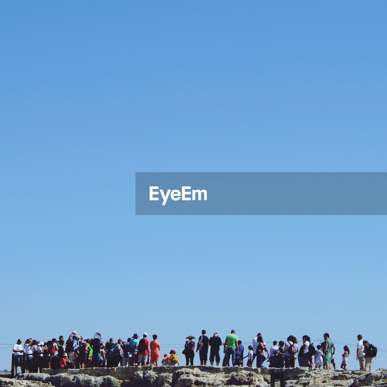 People standing on edge of rock