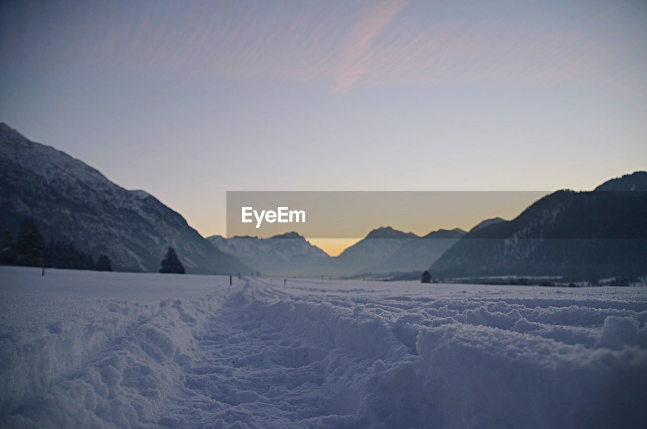 Scenic view of landscape against sky during winter