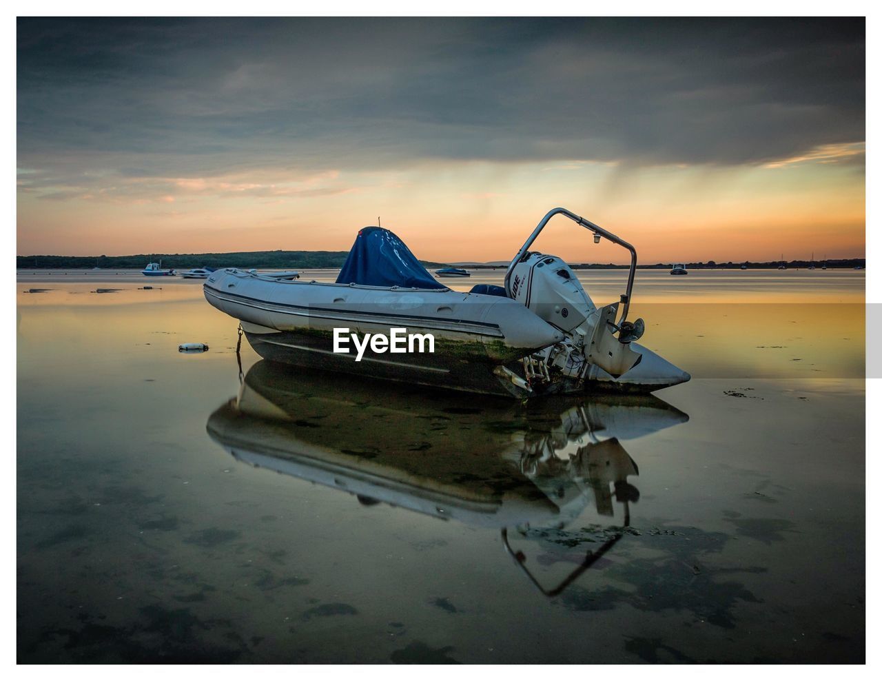 FISHING BOAT MOORED IN SEA AGAINST SKY DURING SUNSET