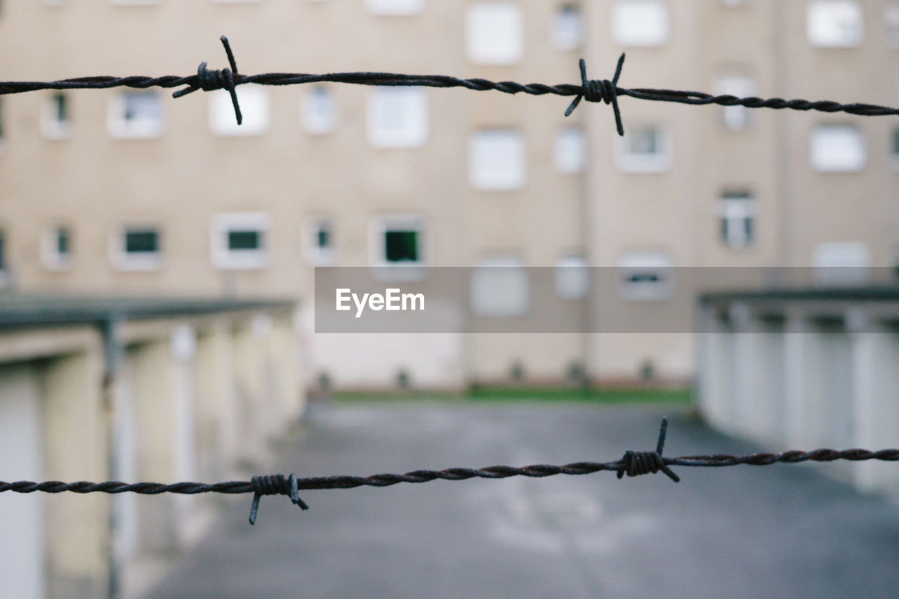 Close-up of barbed wire in city