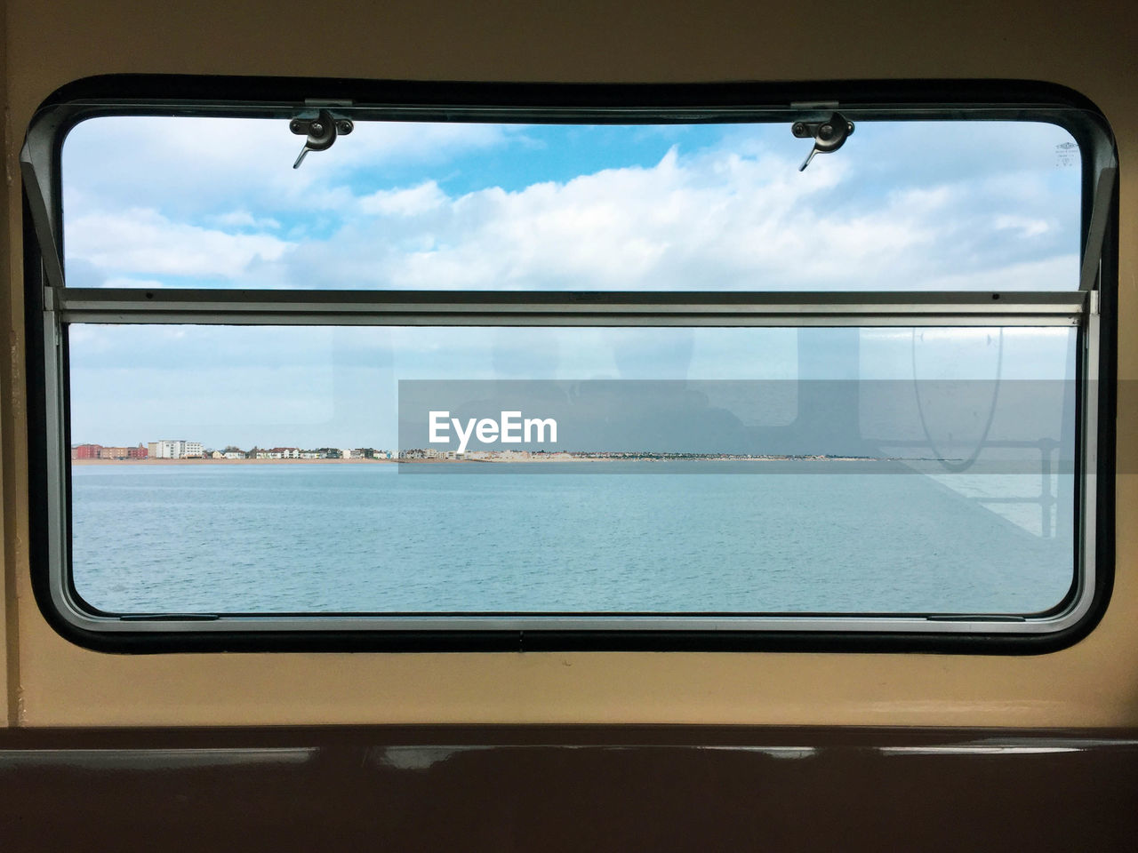 Scenic view of sea seen through train window